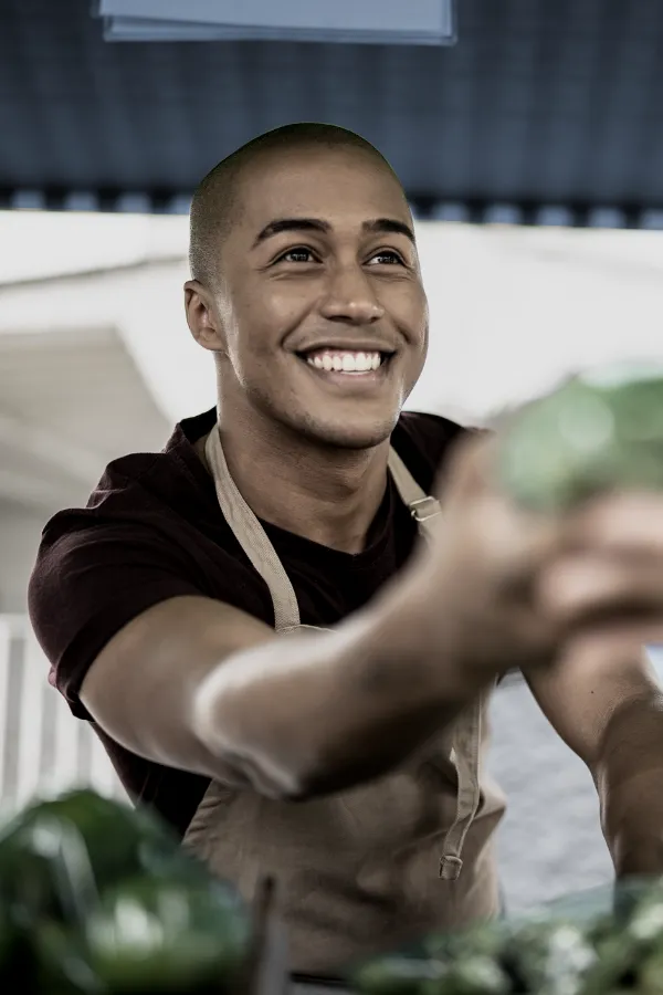 young man working at a produce stand